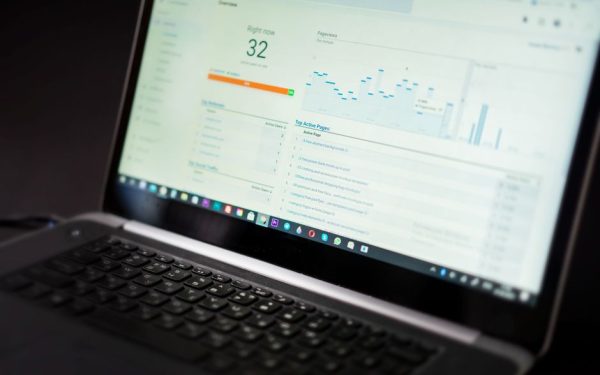 A laptop displaying an analytics dashboard with real-time data tracking and analysis tools.