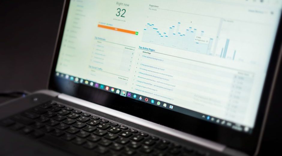 A laptop displaying an analytics dashboard with real-time data tracking and analysis tools.