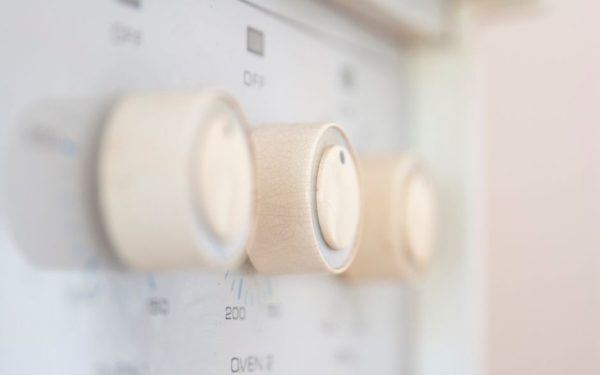 Artistic close-up of stove control knobs, highlighting design details in a kitchen setting.