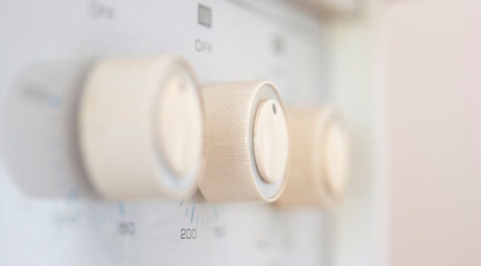 Artistic close-up of stove control knobs, highlighting design details in a kitchen setting.