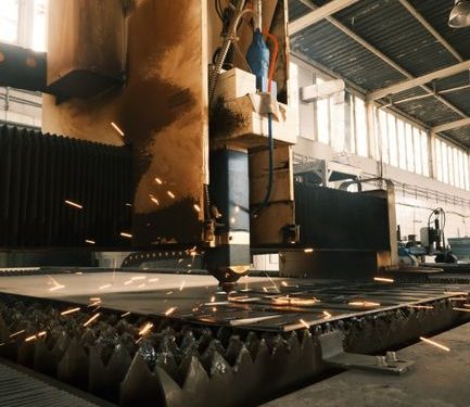 High-tech laser cutter operating in a modern industrial environment.